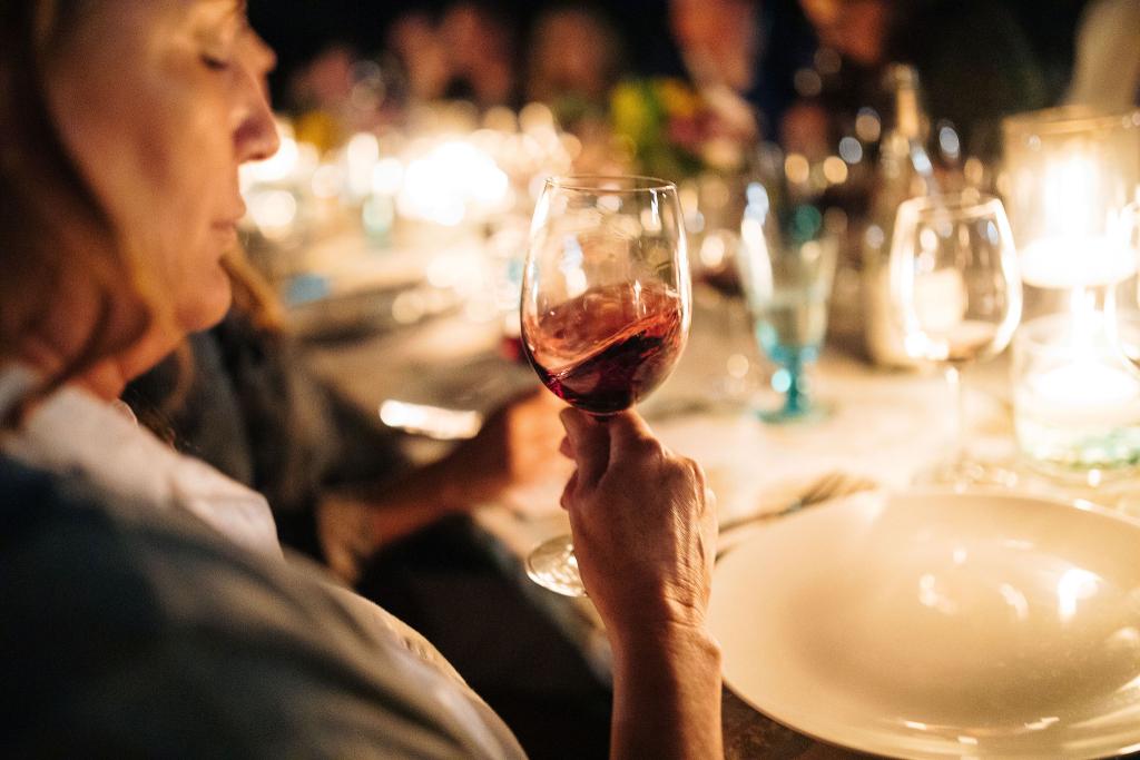 Guest Enjoying Elizabeth Spencer Wine at an Evening Outdoor Event